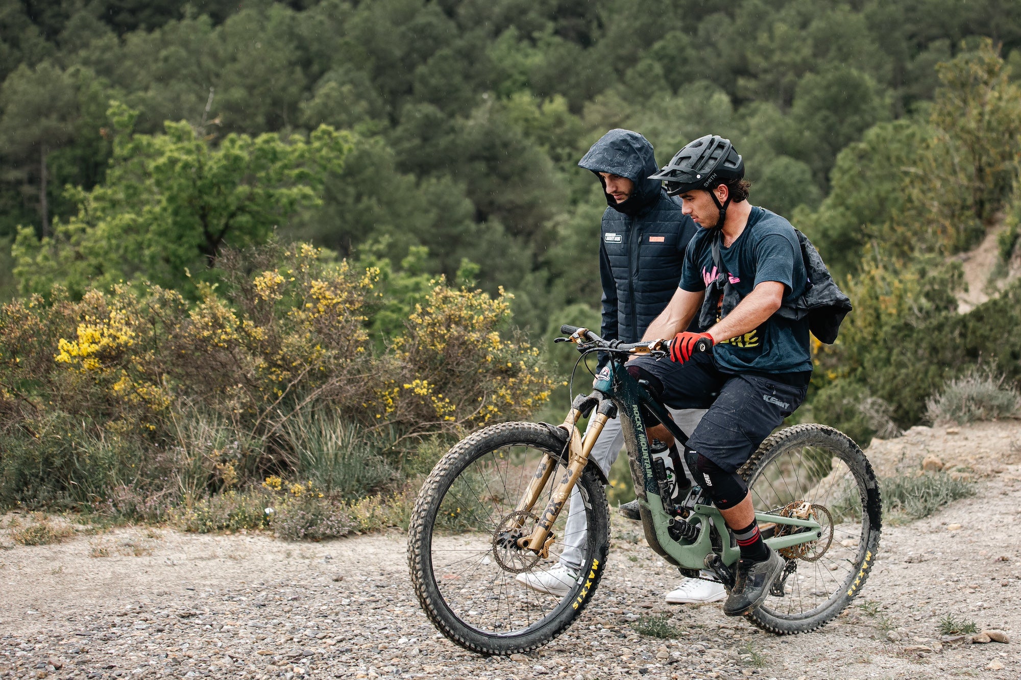 TRP mountain bike brake component showing high-quality construction and finishing on a bike with a person sitting on it