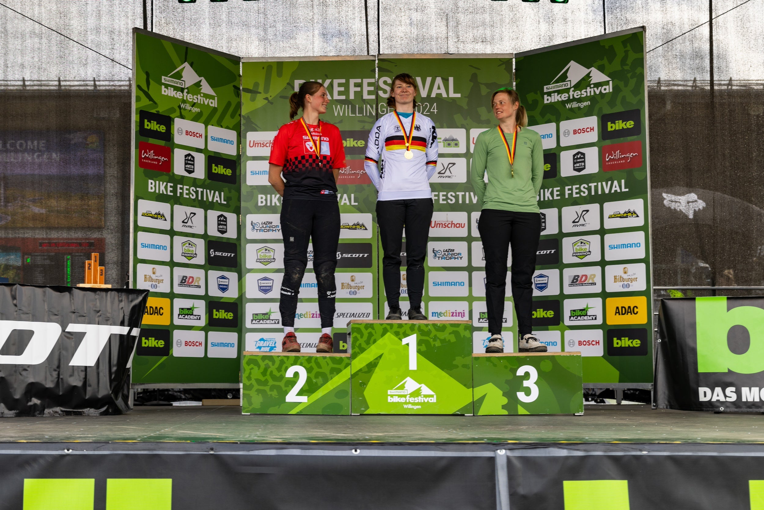 female MTB rider celebrating with a medal at the German Enduro Championship — supported by TRP components