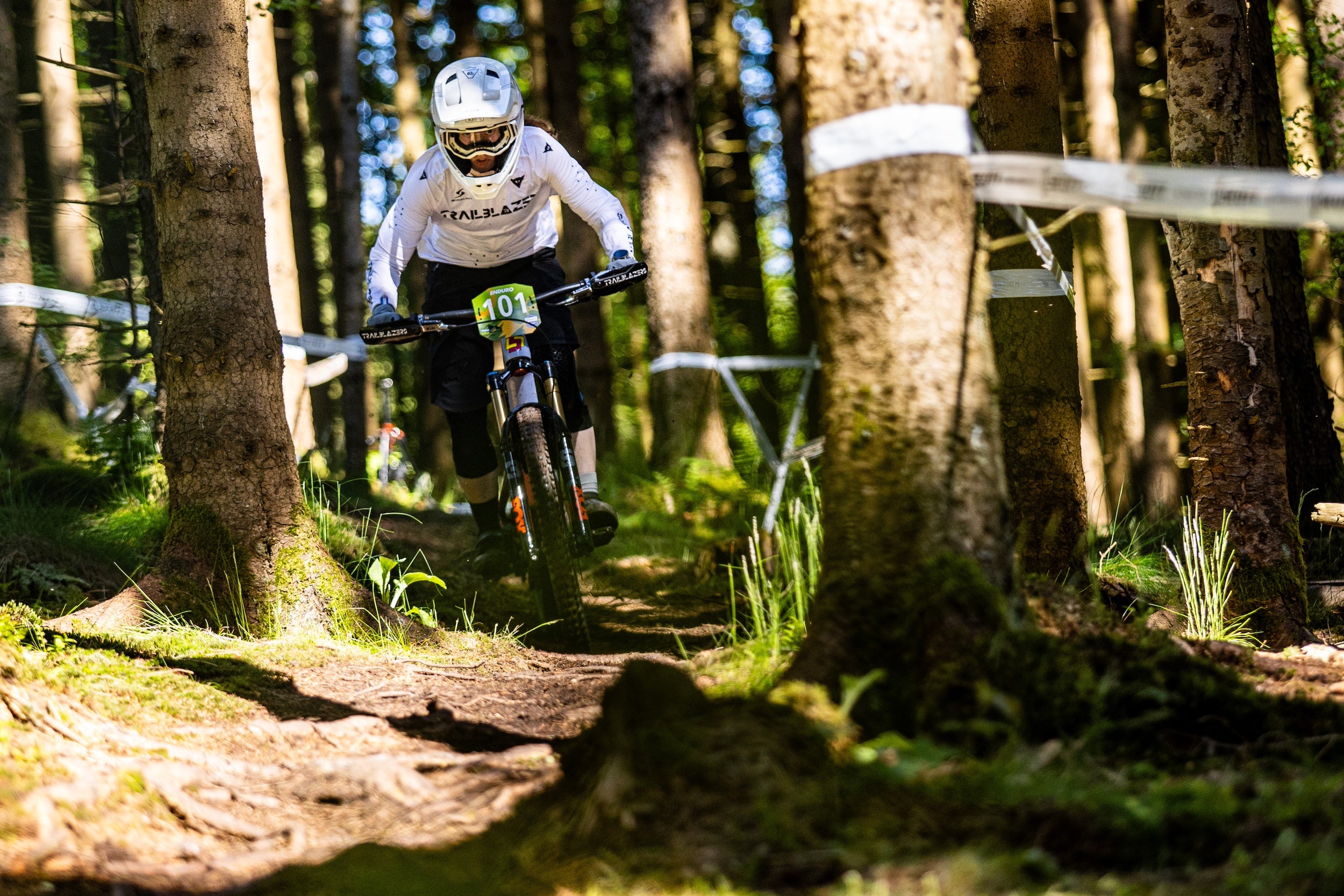 female MTB rider celebrating with a medal at the German Enduro Championship — supported by TRP components