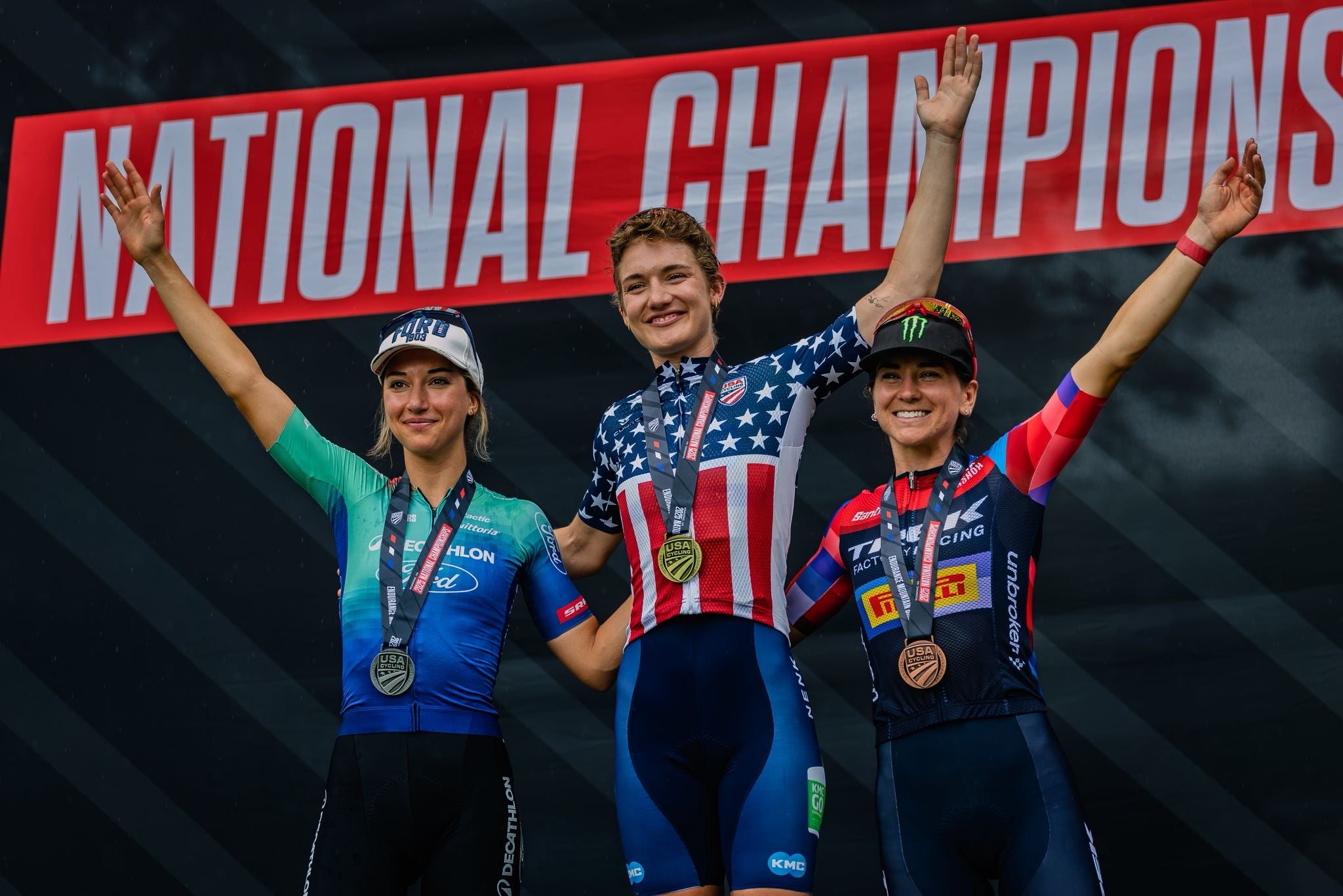 female mountain bikers on a podium with Kelsey Urban winning US championships