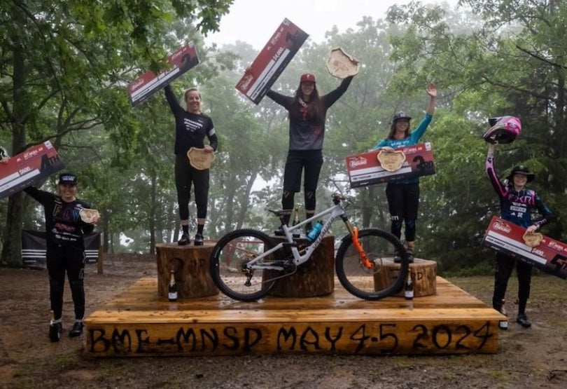 Professional mountain bike racer celebrating victory using TRP brake systems in competitive racing