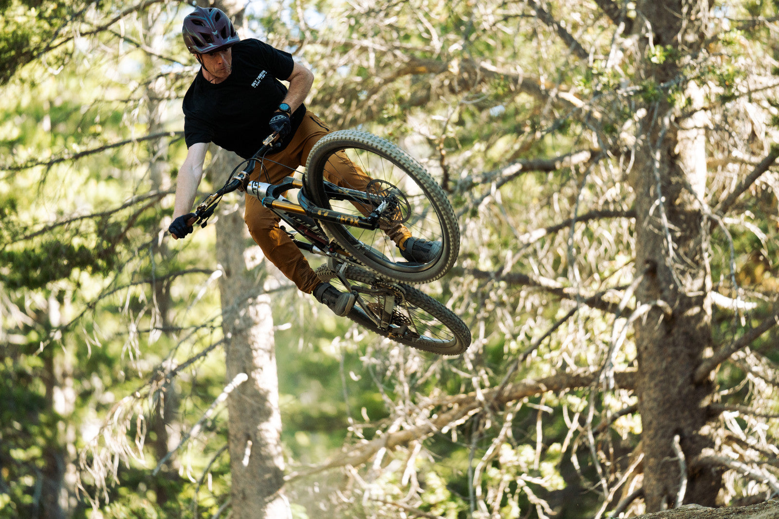 Mountain biker mid air on a bike with TRP components