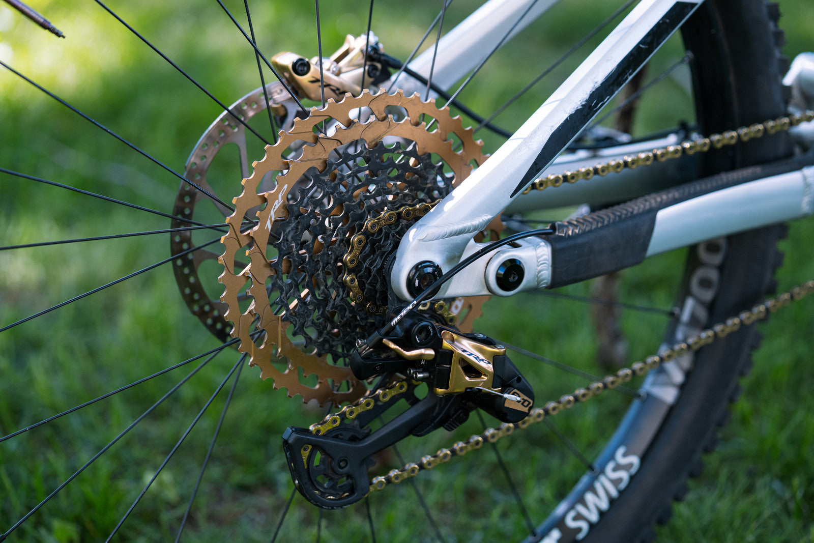 Close-up of TRP derailleur and cassette in gold mounted on a bicycle