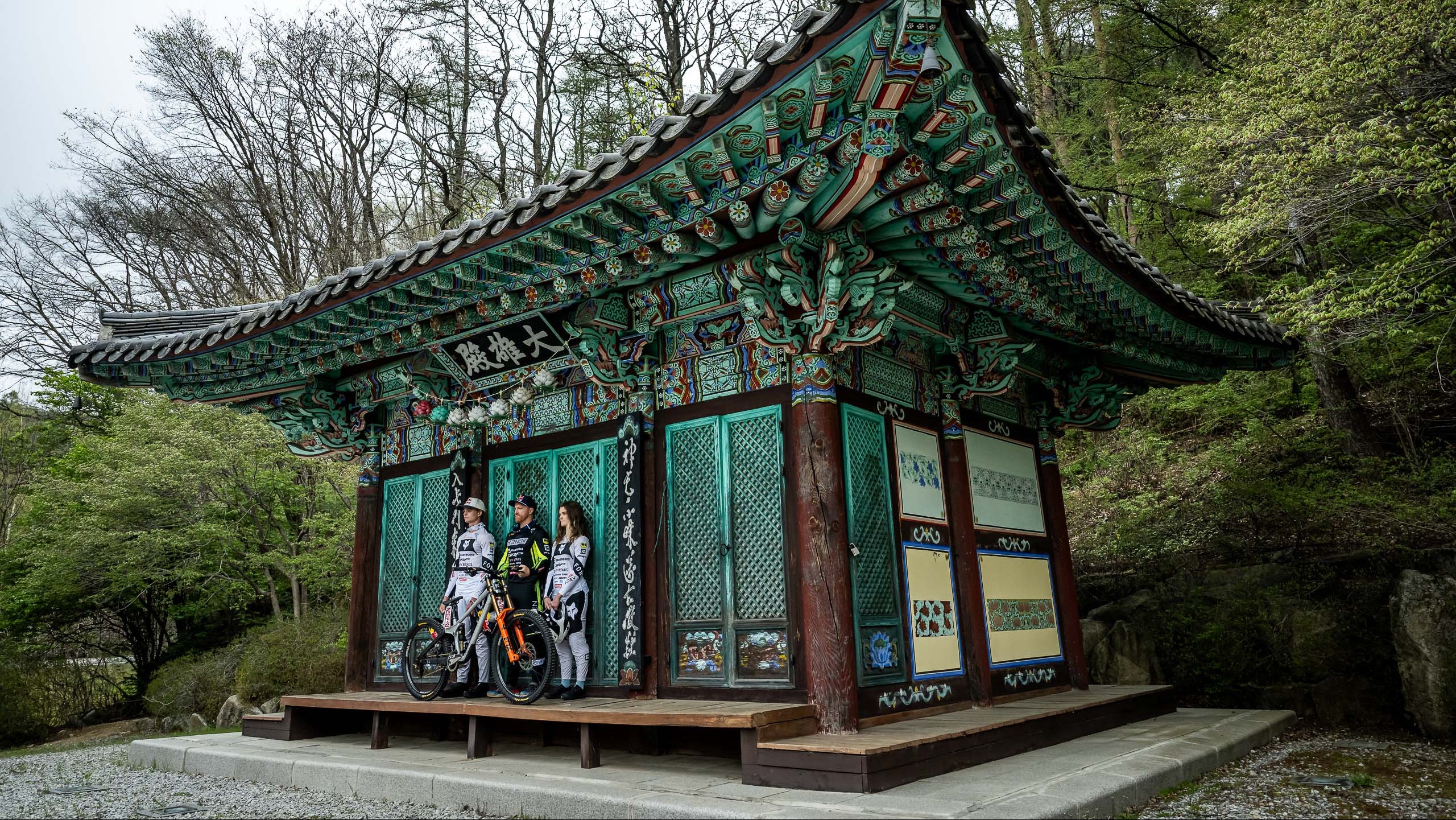 Traditional Korean building with people standing in front of it