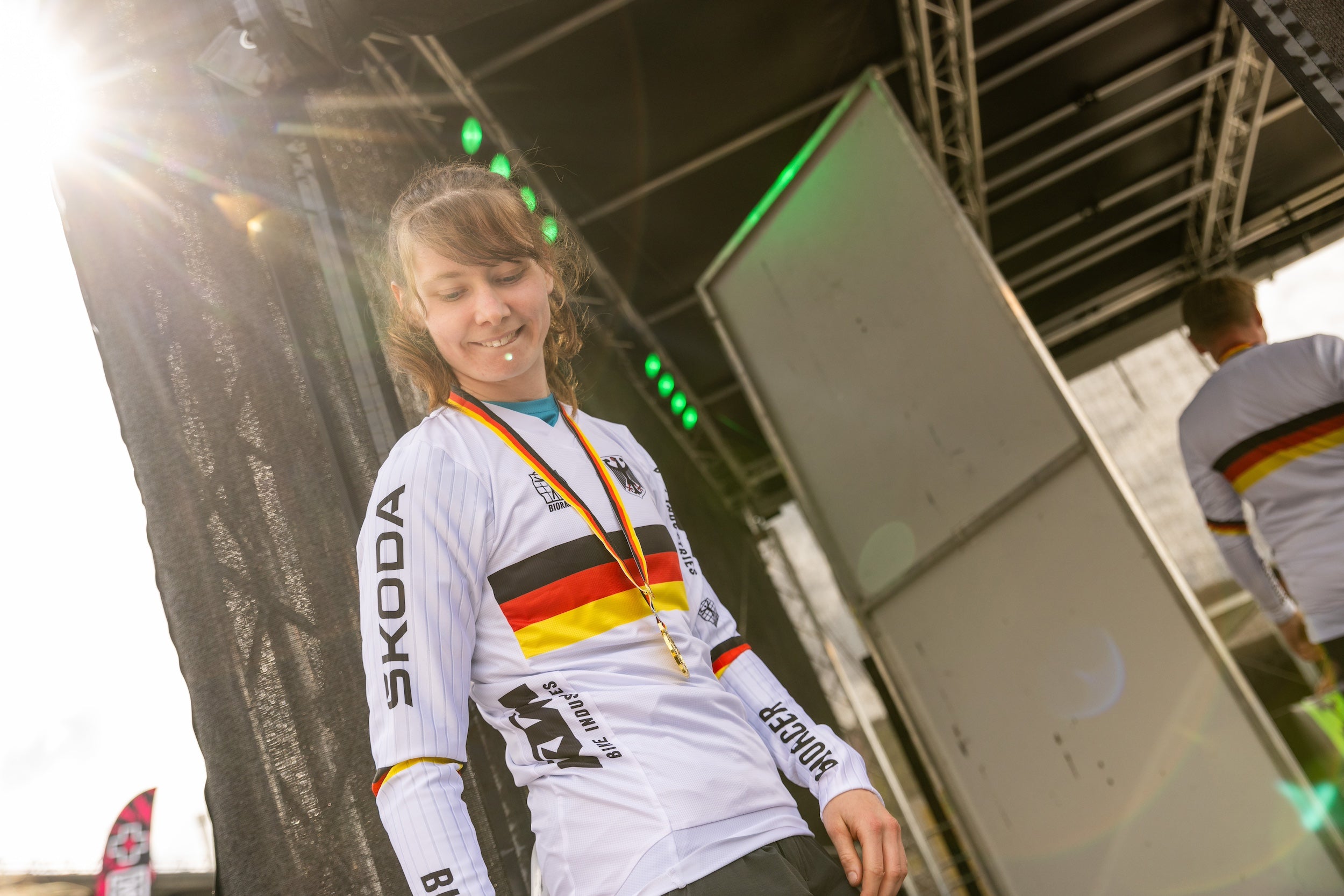 female MTB rider celebrating with a medal at the German Enduro Championship — supported by TRP components