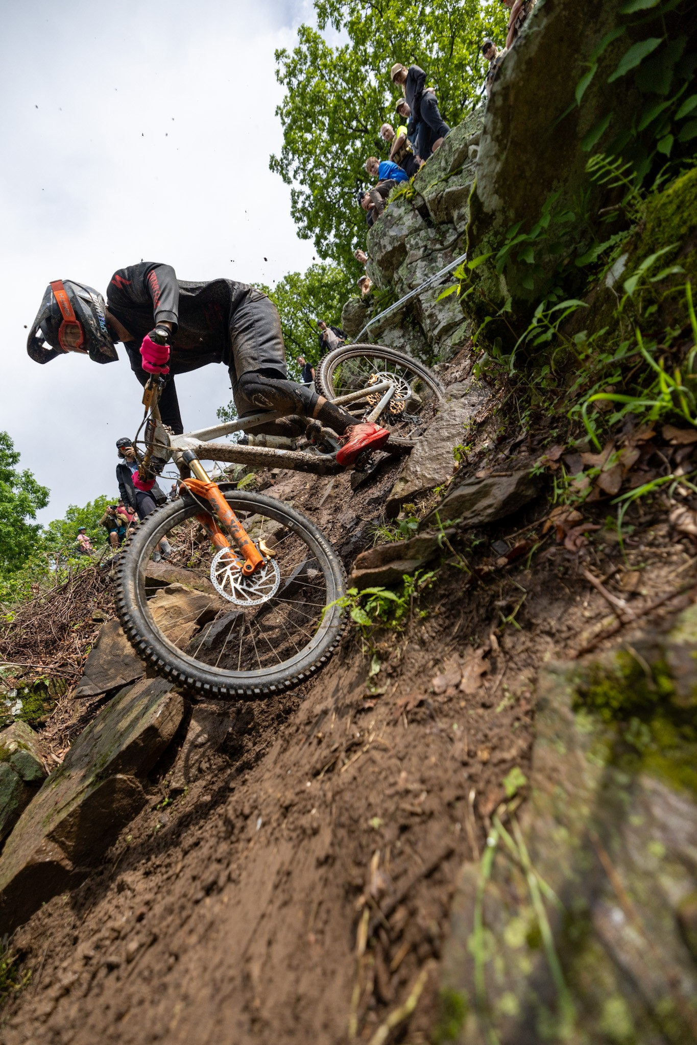 Professional mountain bike racing action featuring TRP brake systems in competitive cycling environment