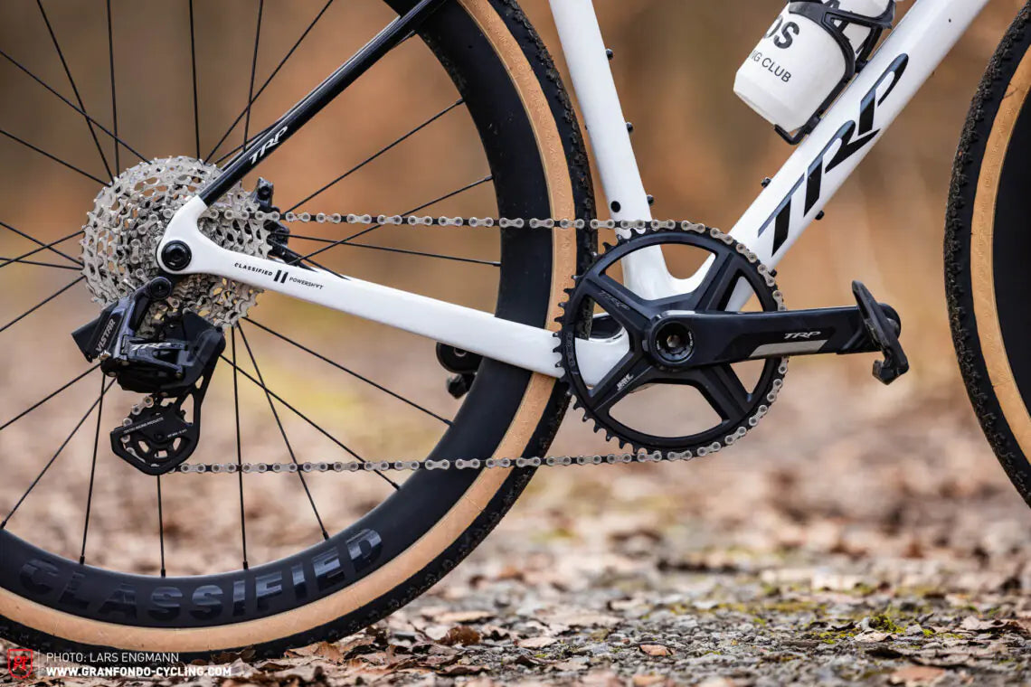 Close-up of a bicycle chain and gear system on a blurred natural background