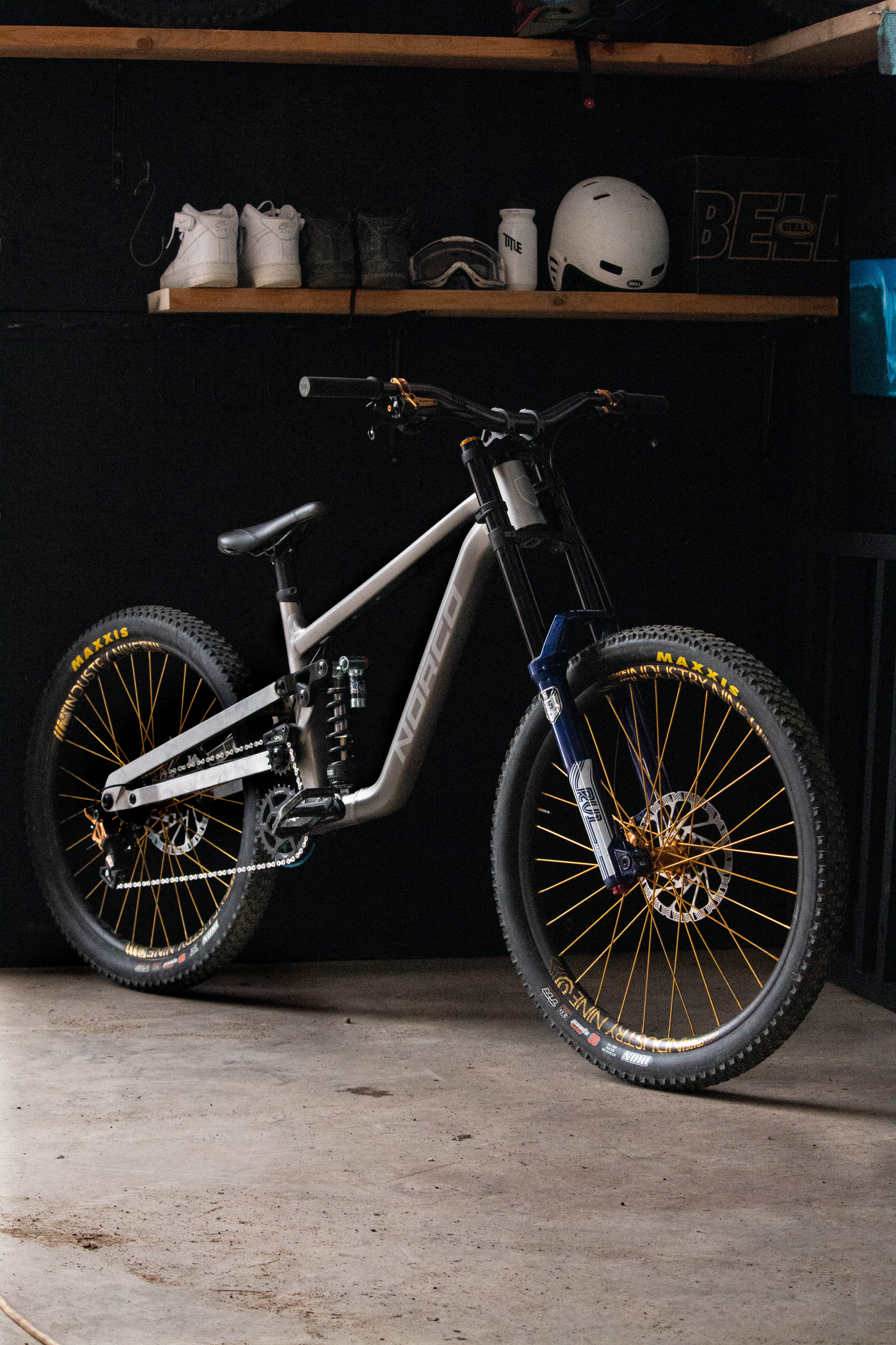 Bicycle with gold rims in a garage setting